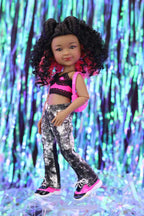 Doll with curly hair wearing a black and pink outfit against a colorful, glittery background