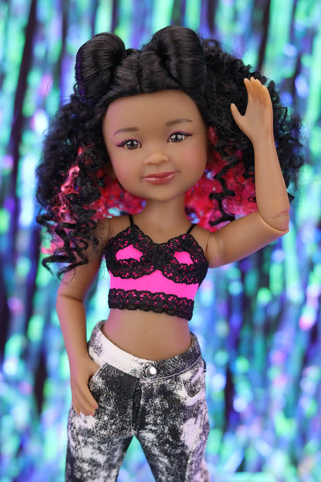 Doll with styled hair against a colorful, blurred background