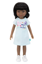 Doll wearing a light blue dress with colorful graphics on a white background