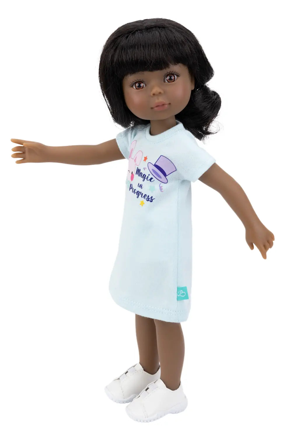 Doll wearing a light blue dress with colorful graphics on a white background