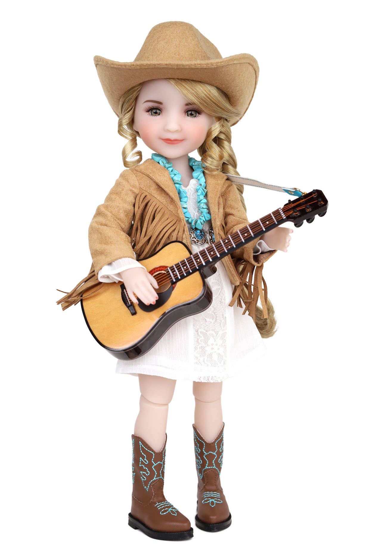 Doll dressed as a cowboy holding a guitar on a white background