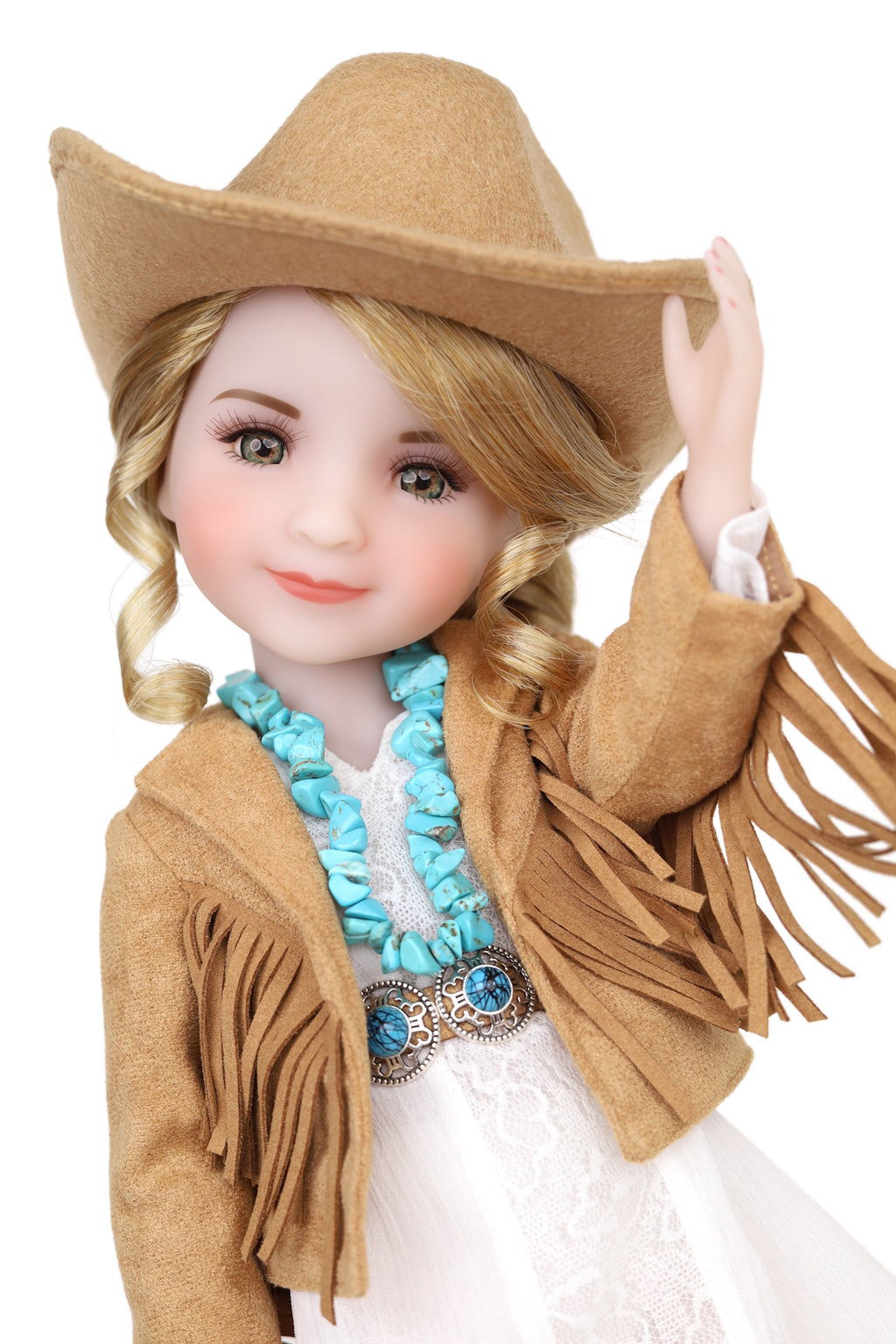 Doll wearing a cowboy hat, jacket with fringes, and white dress on a white background