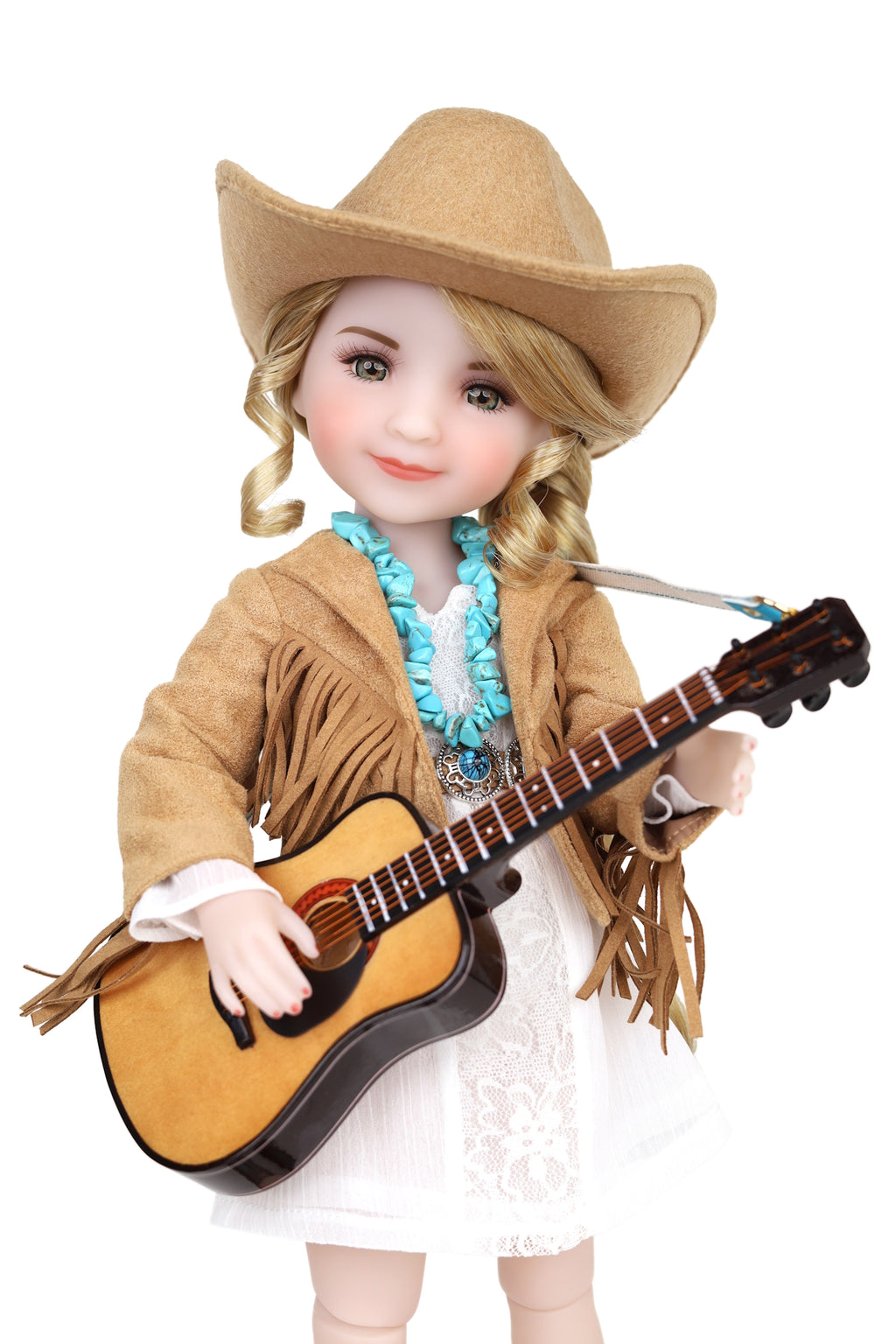 Doll dressed as a cowboy holding a guitar on a white background