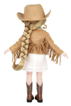 Doll dressed in a cowboy outfit with a hat, fringed jacket, skirt, and boots on a white background