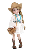 Doll in a cowboy outfit with a hat, boots, and fringed jacket on a white background