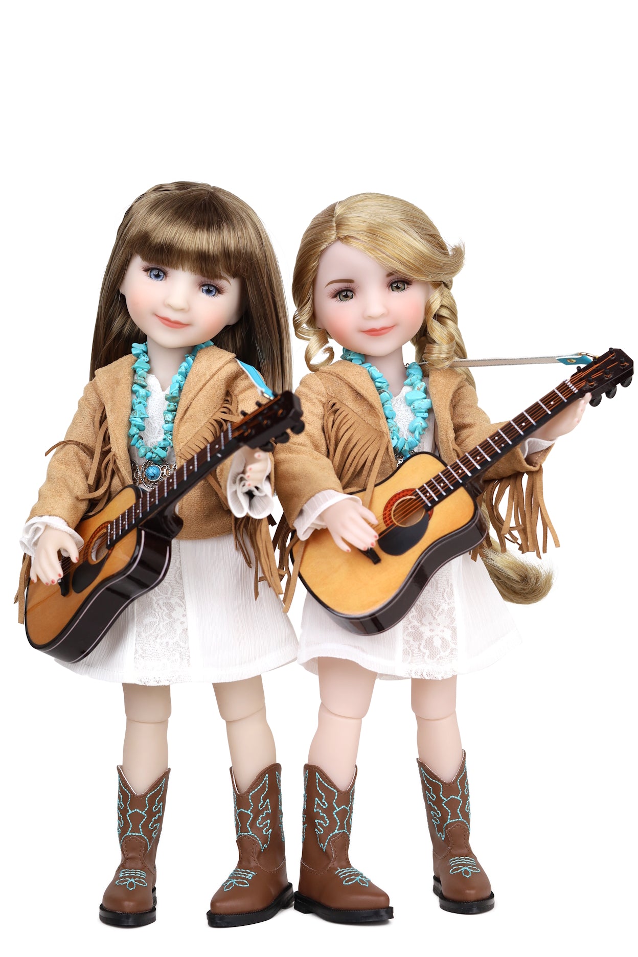 Two dolls with guitars on a white background