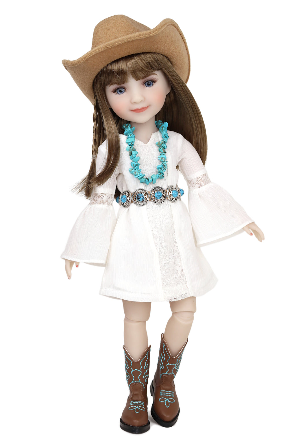 Doll wearing a white dress, brown cowboy hat, and boots with turquoise designs on a white background