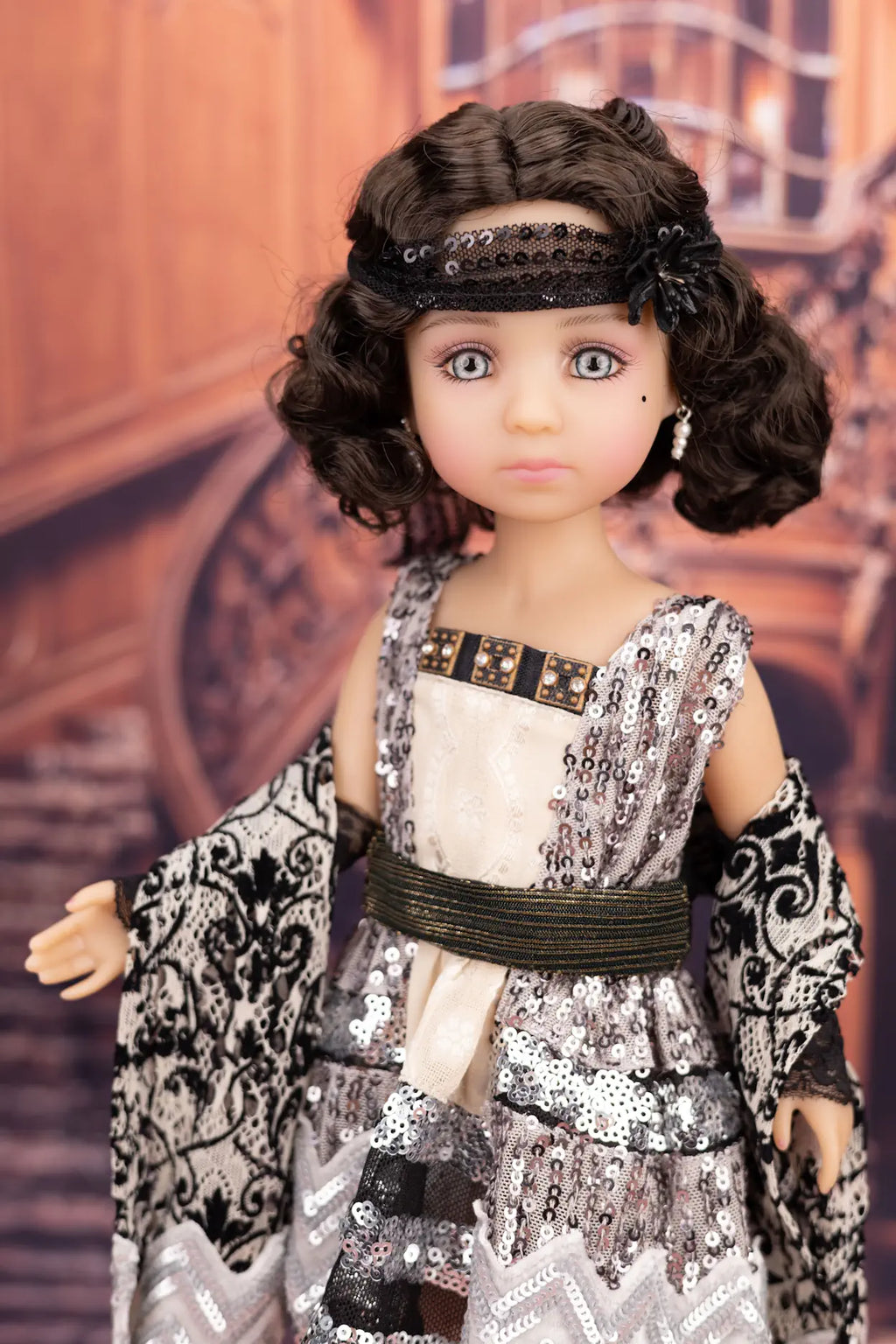 Doll with a detailed outfit and accessories against a blurred background