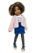 Doll wearing a pink fluffy jacket, blue dress, and patterned leggings on a white background