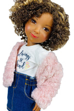 Doll wearing a pink jacket, white shirt with text, and blue jeans on a white background