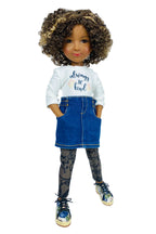Doll wearing a white shirt with text and a blue denim skirt on a white background