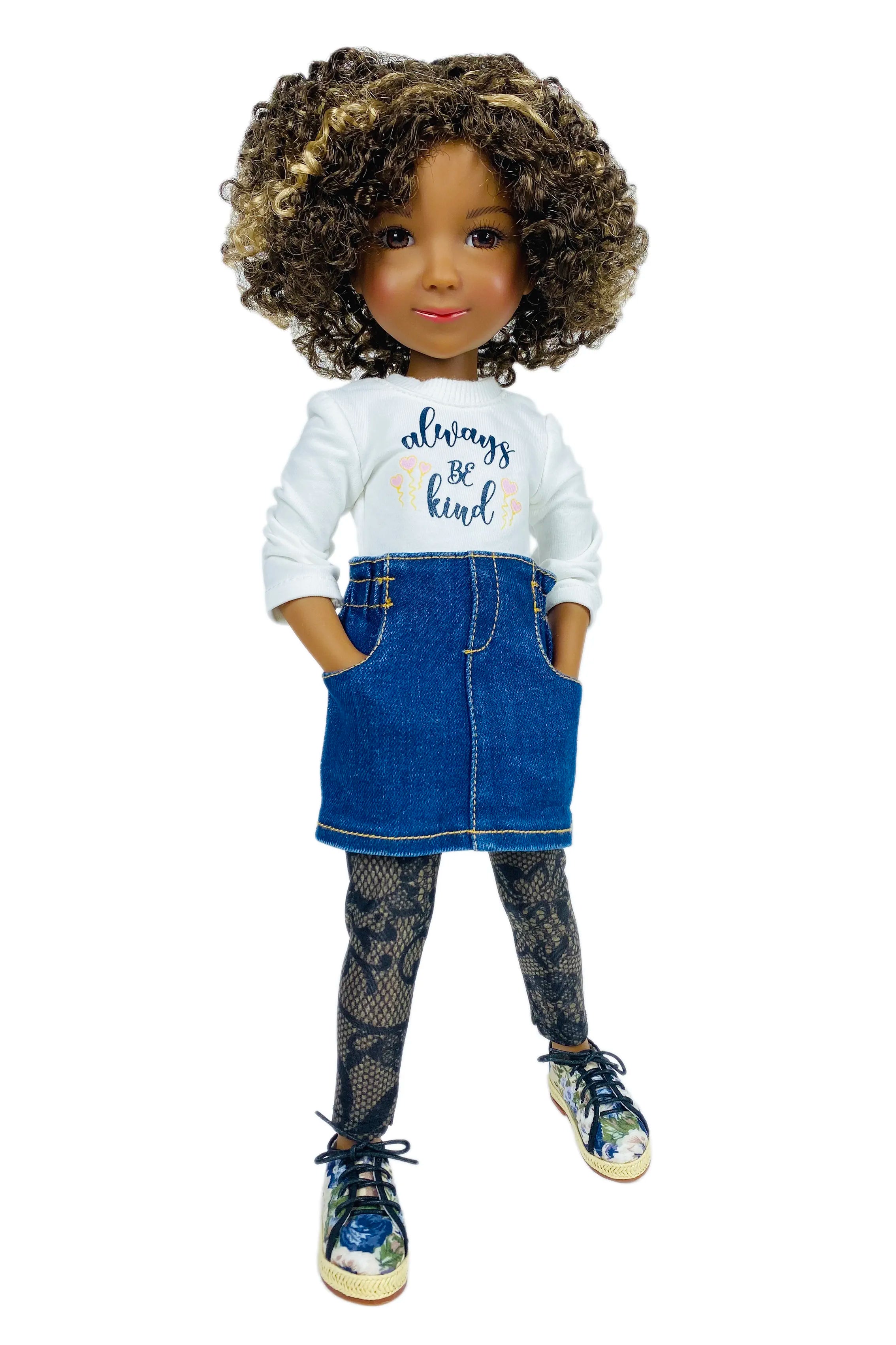 Doll wearing a white shirt with text and a blue denim skirt on a white background