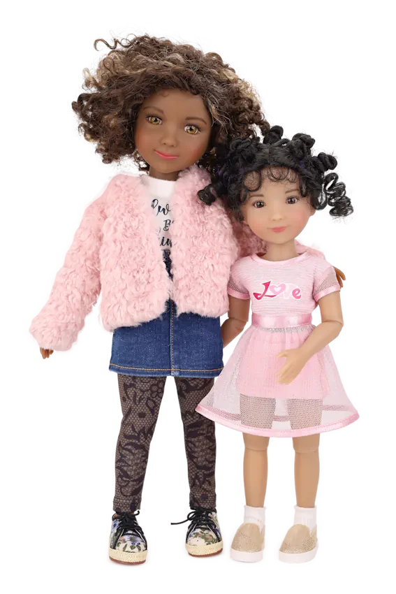 Maya and Minnie, one with a pink fur coat and the other in a pink dress, standing together on a white background.