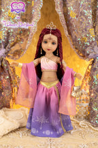Doll in a pink and purple outfit with a tiara against a glittery background