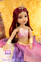 Doll with red hair and a pink and purple outfit against a gold background