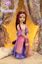 Doll in a purple and pink outfit with a tiara against a glittery background
