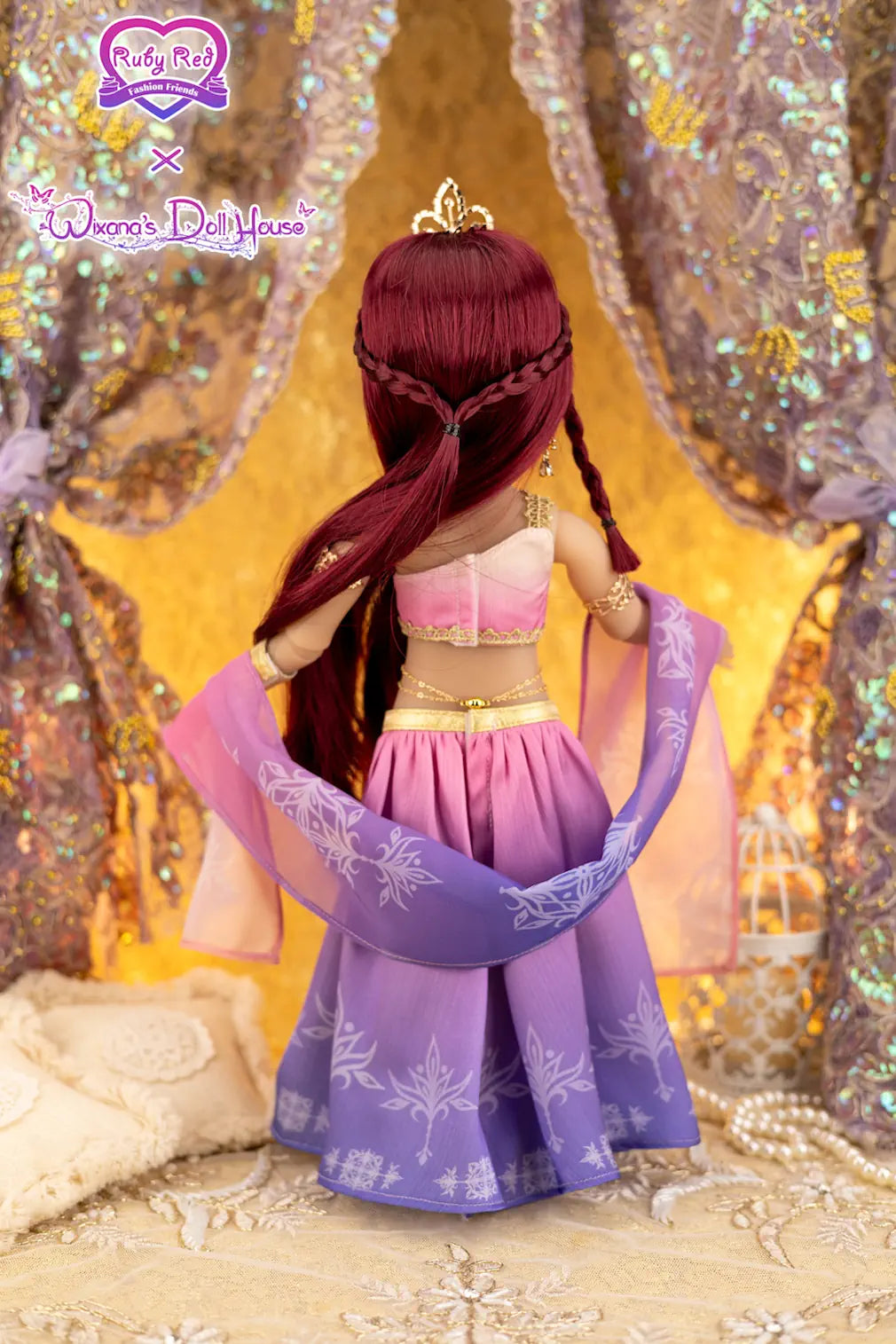 Doll with red hair and a purple outfit in front of a decorative curtain