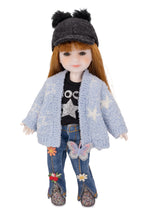 mini Stella doll wearing a blue textured jacket, black top with star design, and jeans with floral patches on a white background.
