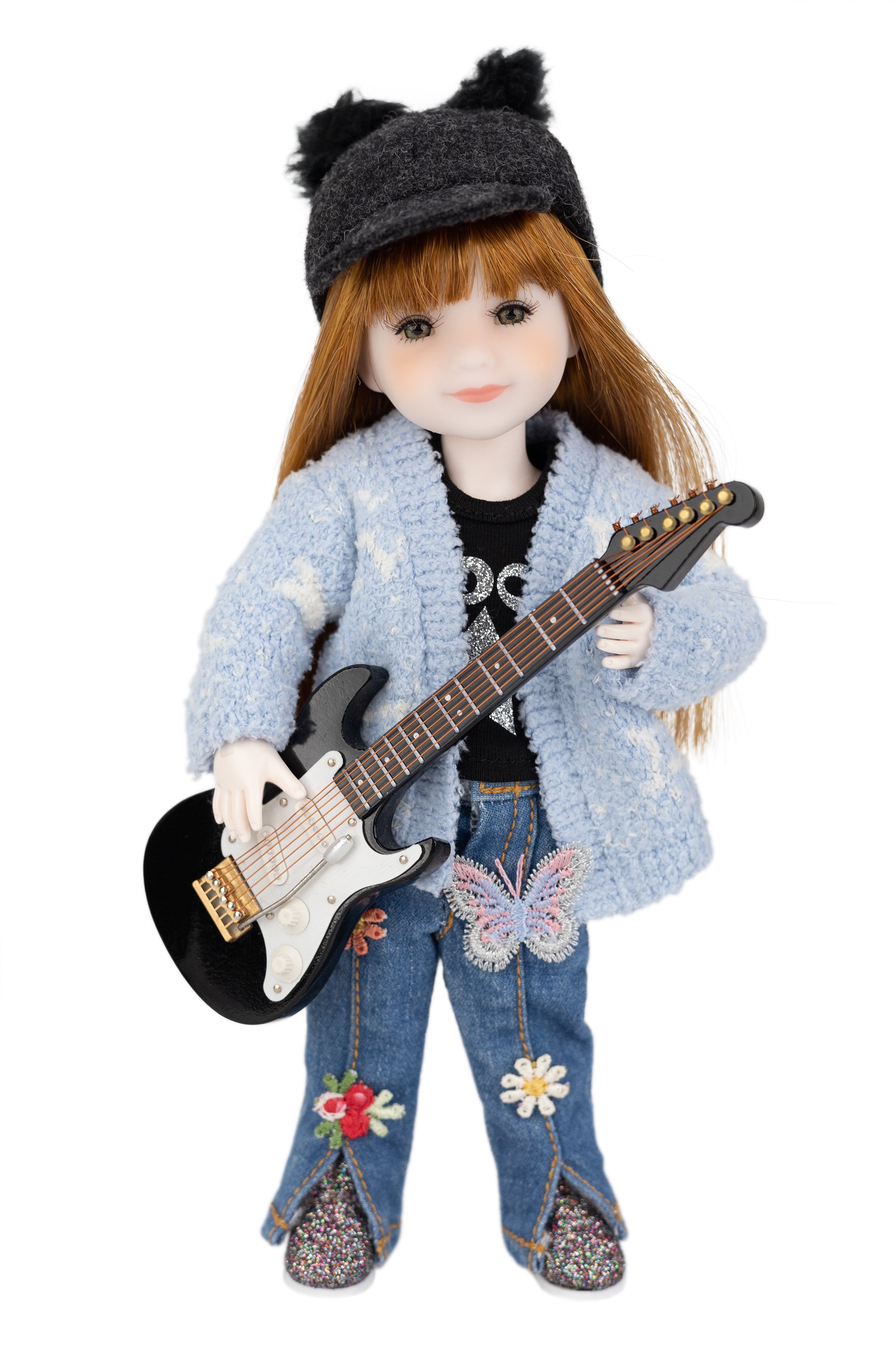 mini Stella doll with long red hair wearing a gray hat, light blue jacket, and jeans holding a guitar on a white background.