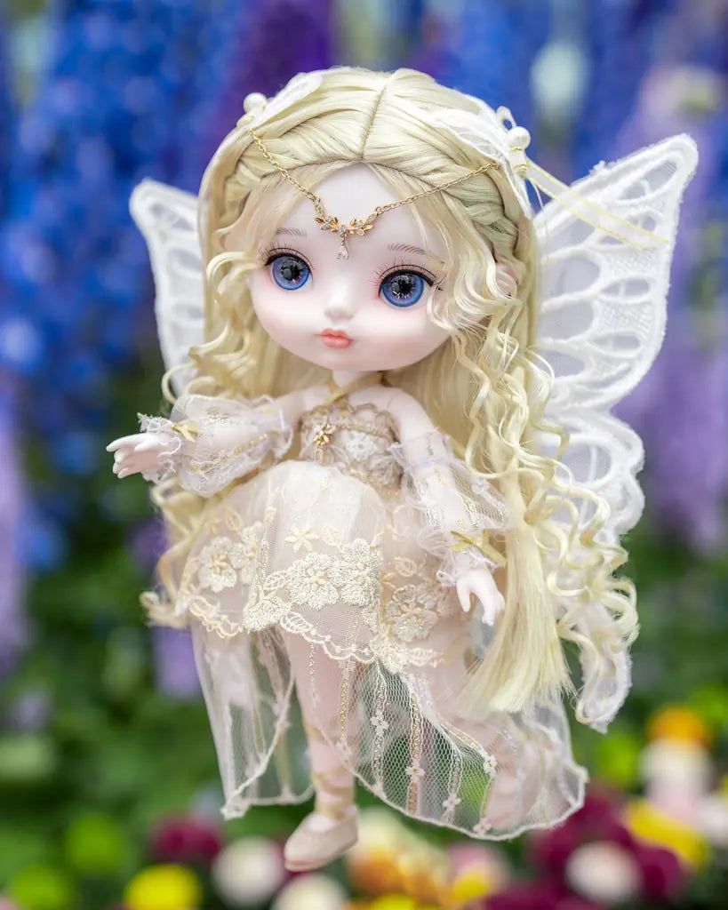 Fairy doll with blonde hair and butterfly wings against a floral background