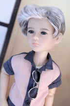 Doll with gray hair wearing a shirt and sunglasses on a neutral background