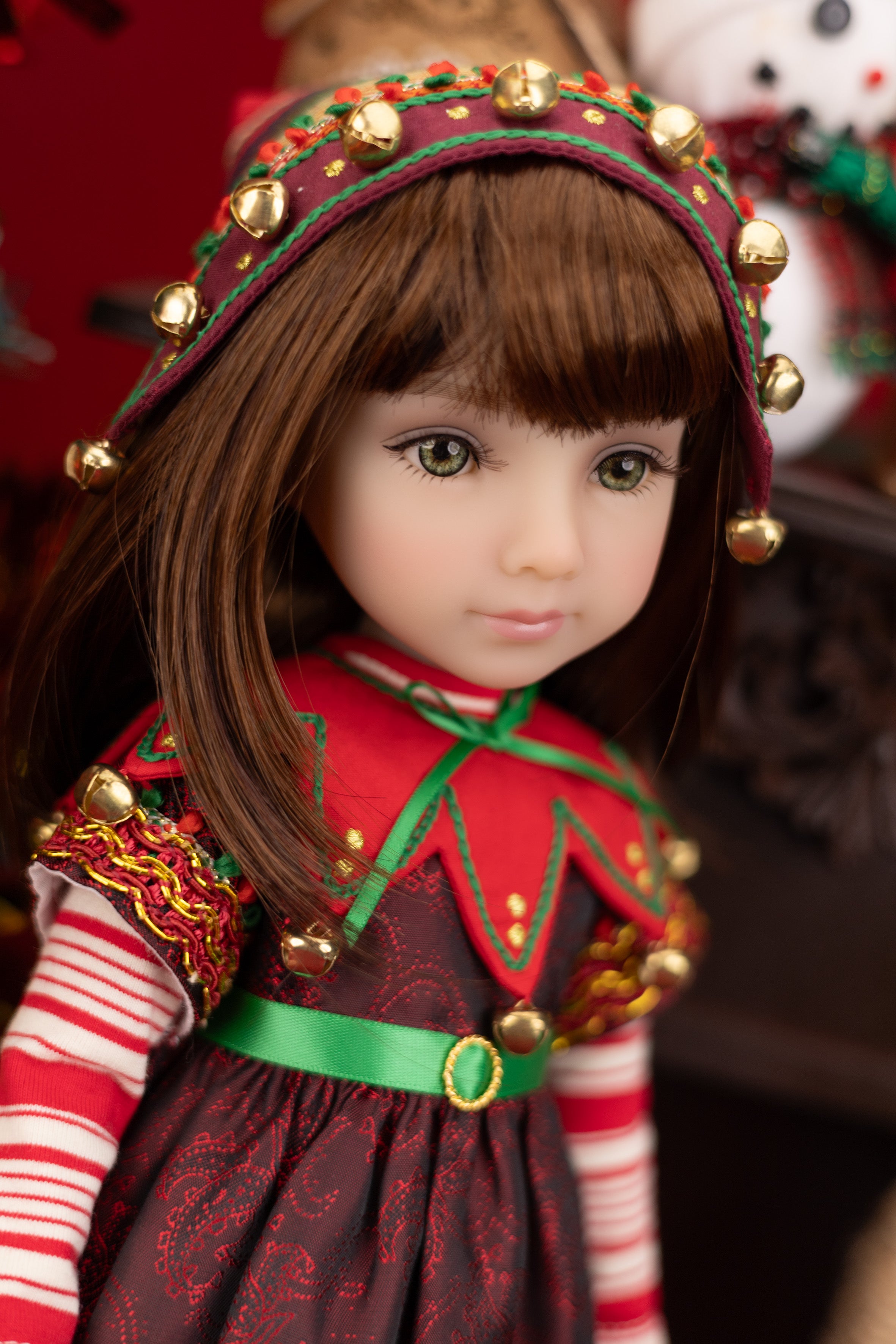 Doll in festive outfit with red and green dress and headband