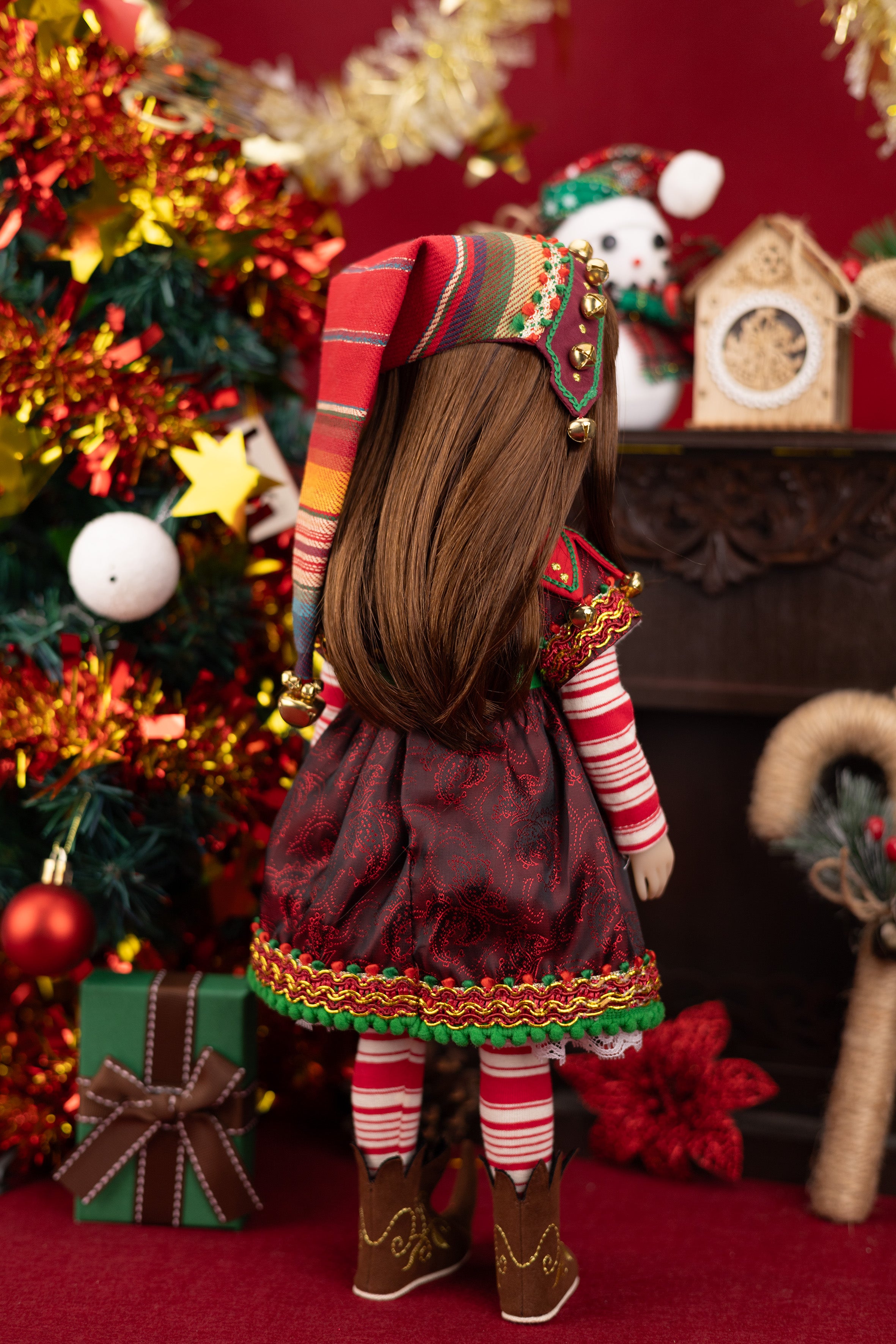 Doll in festive outfit with Christmas decorations in the background