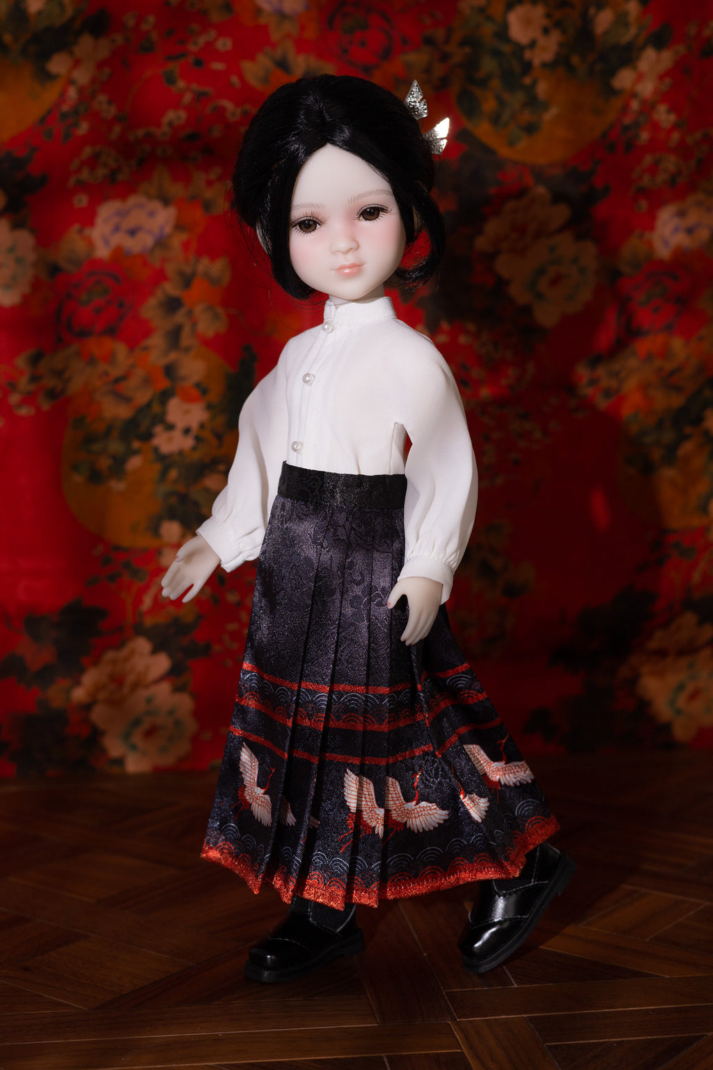Doll wearing a white blouse and pleated skirt against a floral background