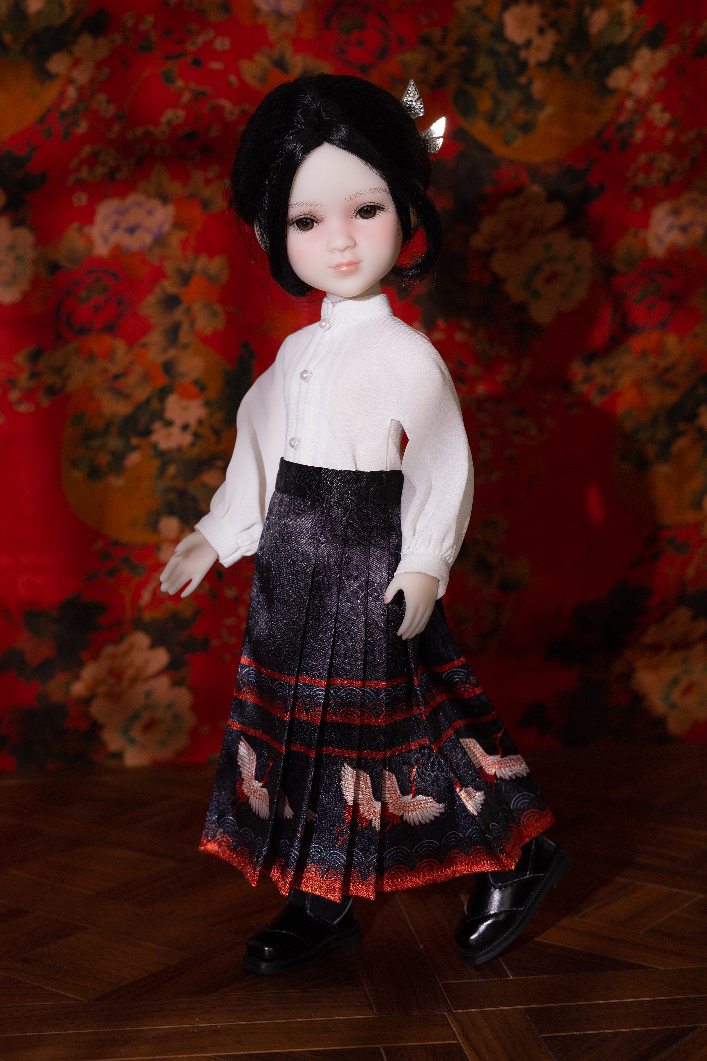 Doll wearing a white blouse and pleated skirt against a floral background