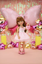 Doll in a pink dress with decorations in the background