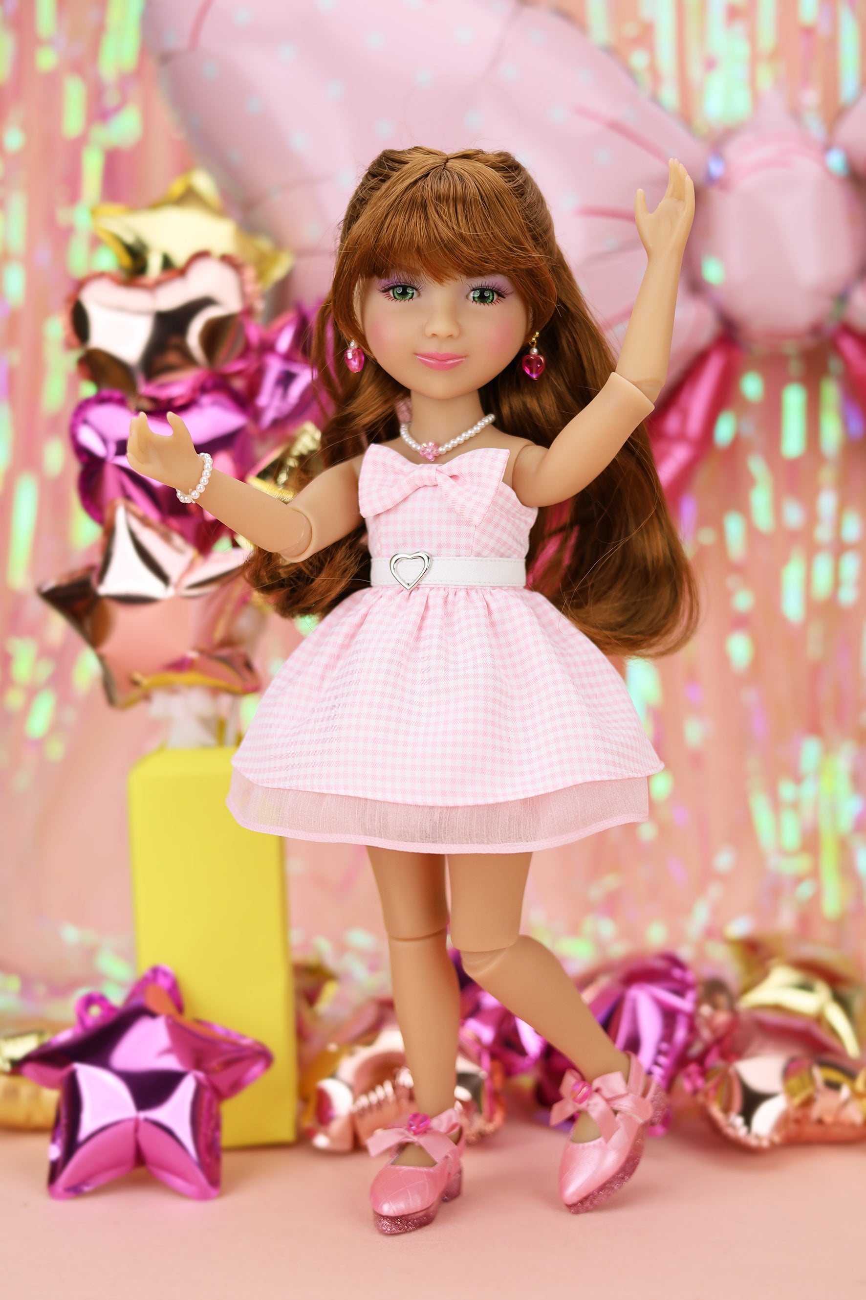 Doll in a pink dress with a festive background