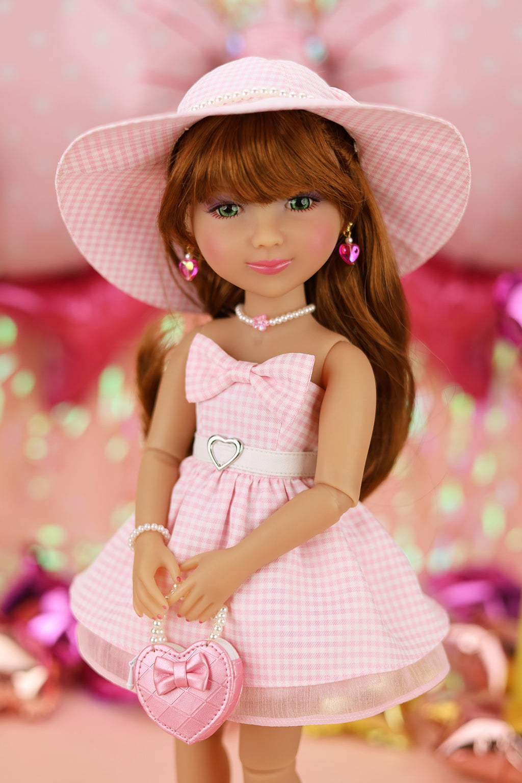 Doll in a pink dress and hat with a heart-shaped bag against a colorful background