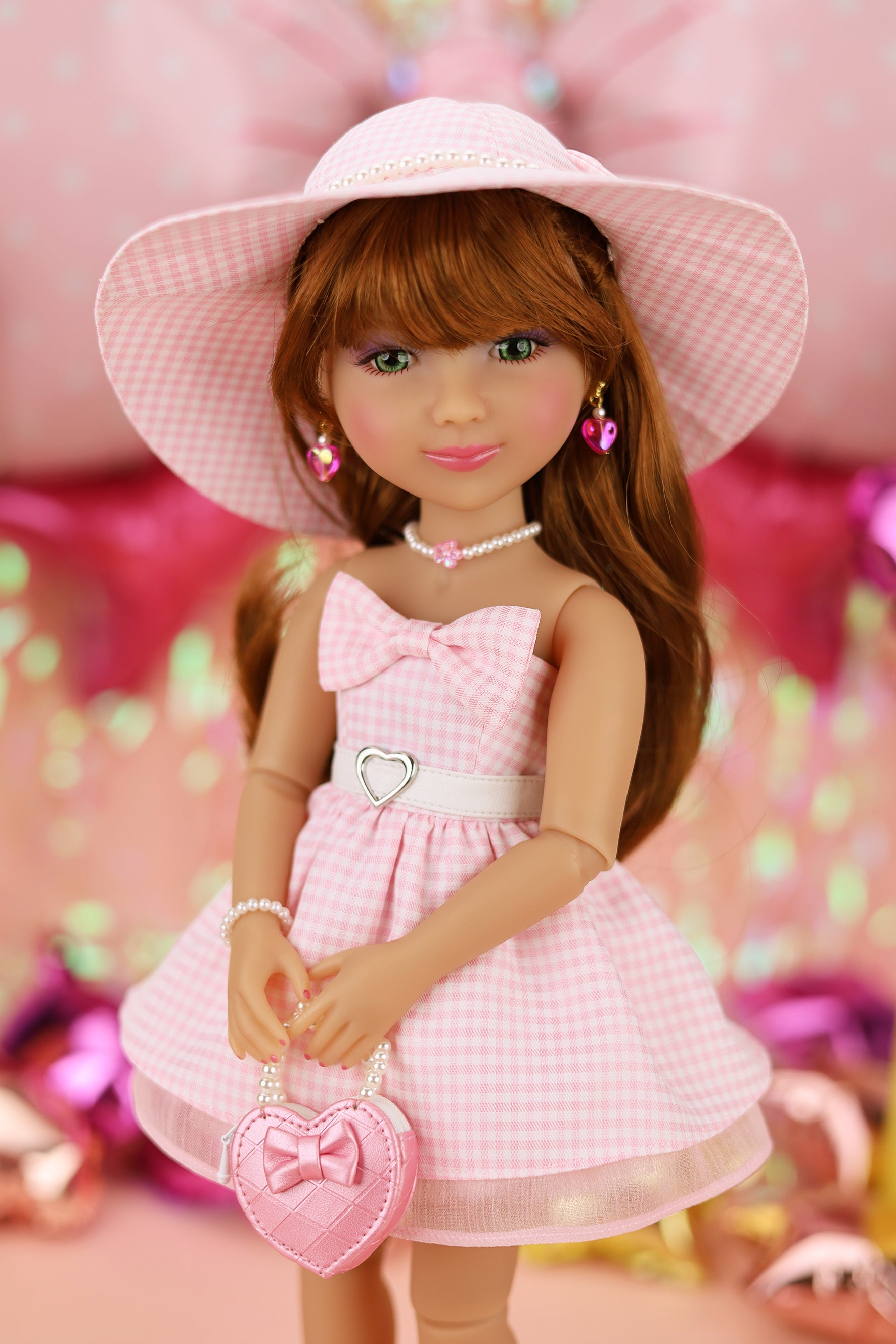 Doll in a pink dress and hat with a heart-shaped bag against a colorful background