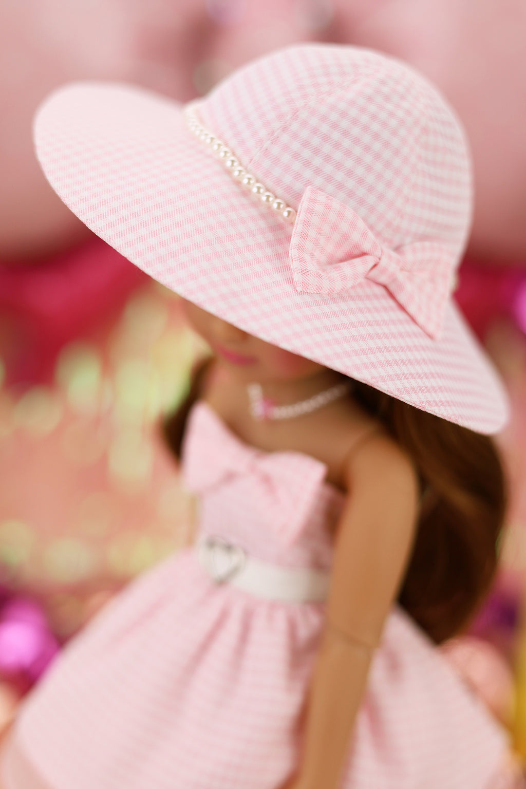 Close-up of a pink hat with a bow on a blurred background