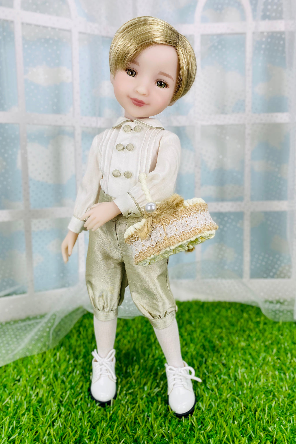 Doll in formal attire with a white jacket and beige pants on grass
