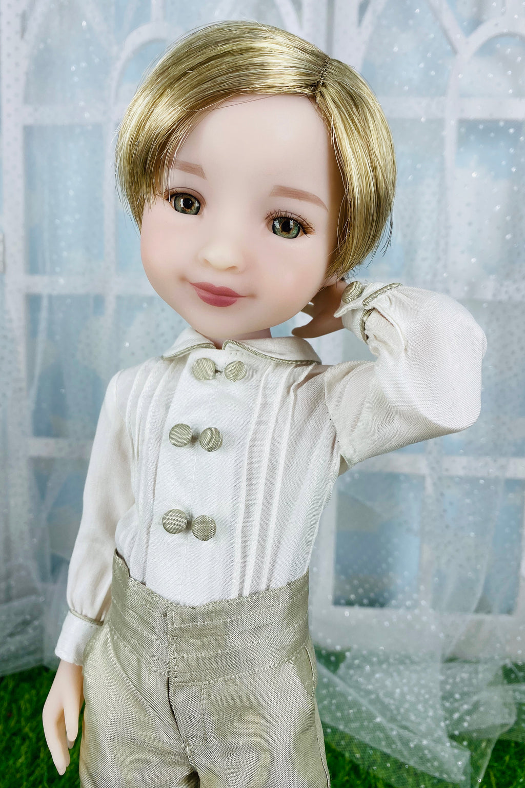 Doll with blonde hair and formal attire against a decorative background