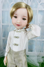 Doll with blonde hair and formal attire against a decorative background