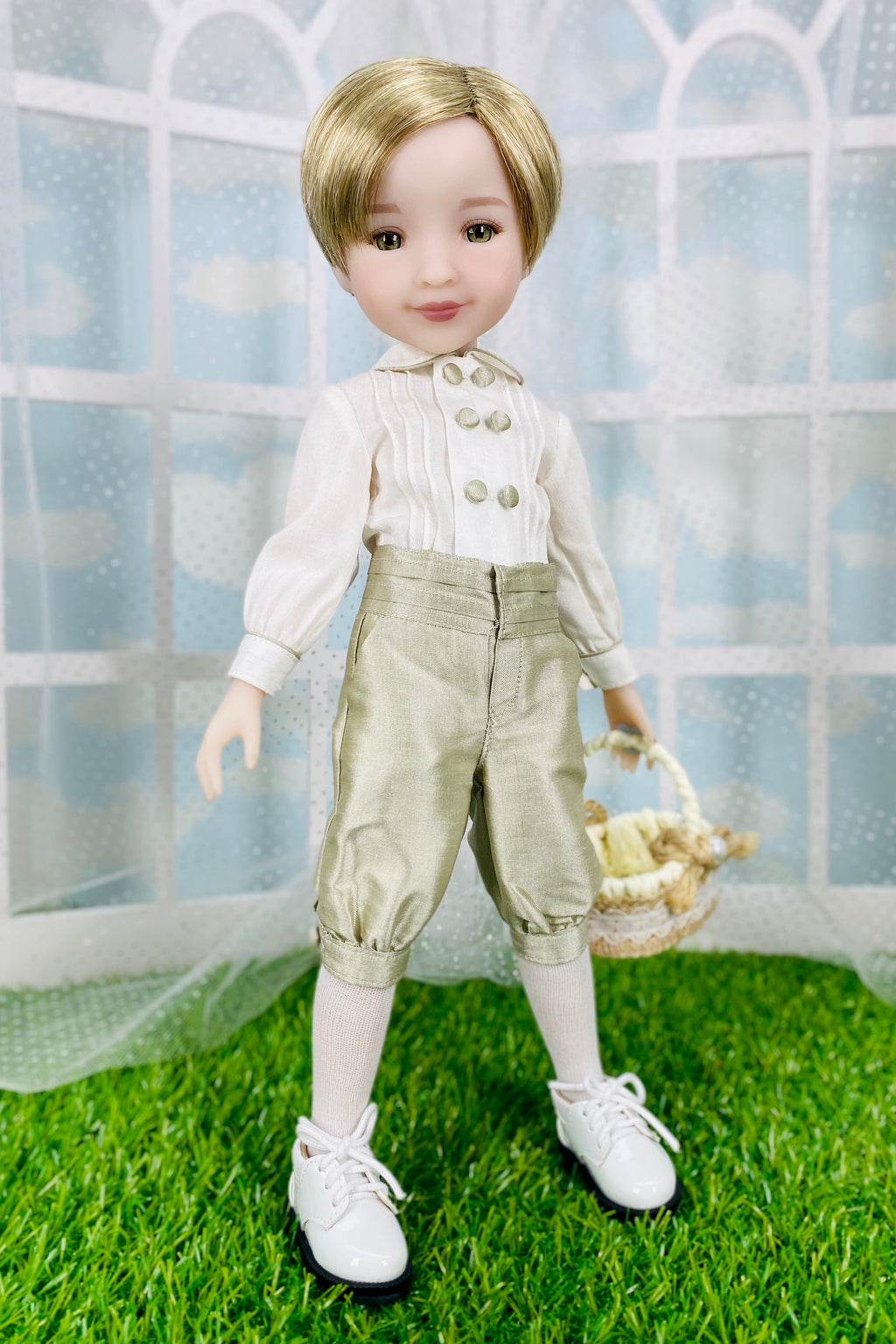 Doll wearing a white shirt with buttons and beige pants, standing on grass with a white lattice background.