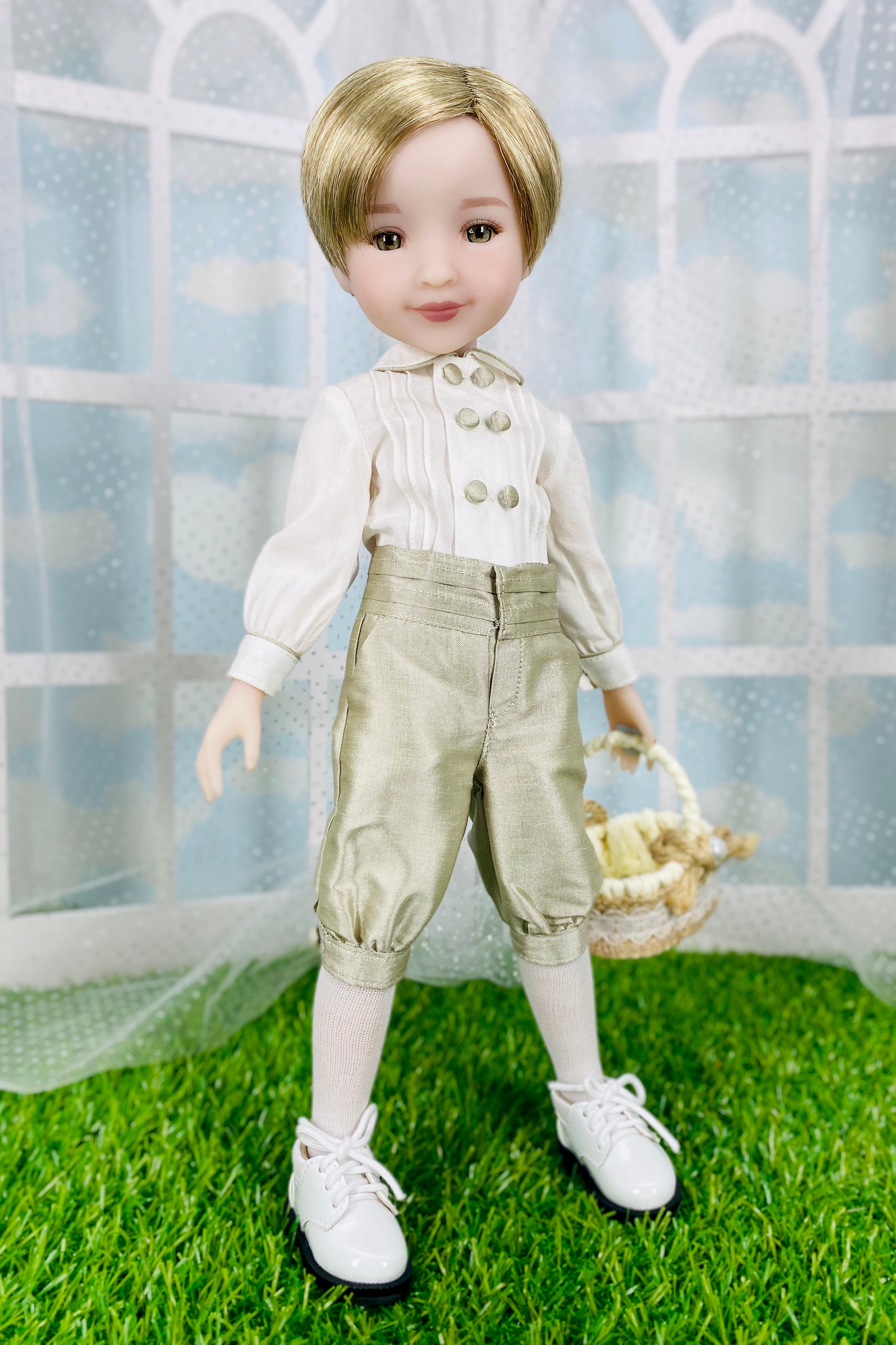Doll wearing a white shirt with buttons and beige pants, standing on grass with a white lattice background.