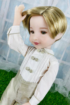 Doll with blonde hair and formal attire sitting on a grassy surface.