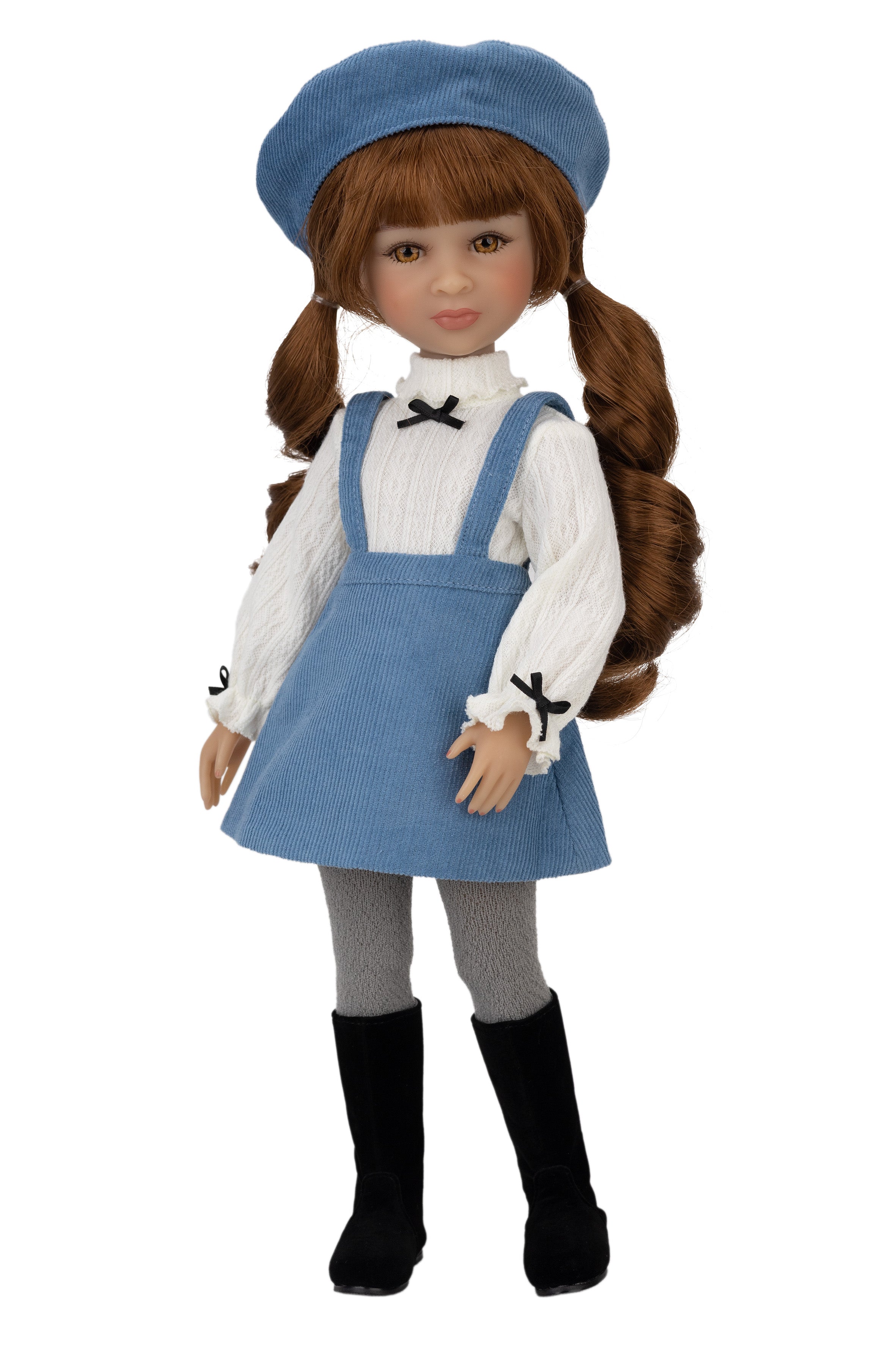 Doll wearing a blue dress with pinafore, white shirt, and black boots on a white background