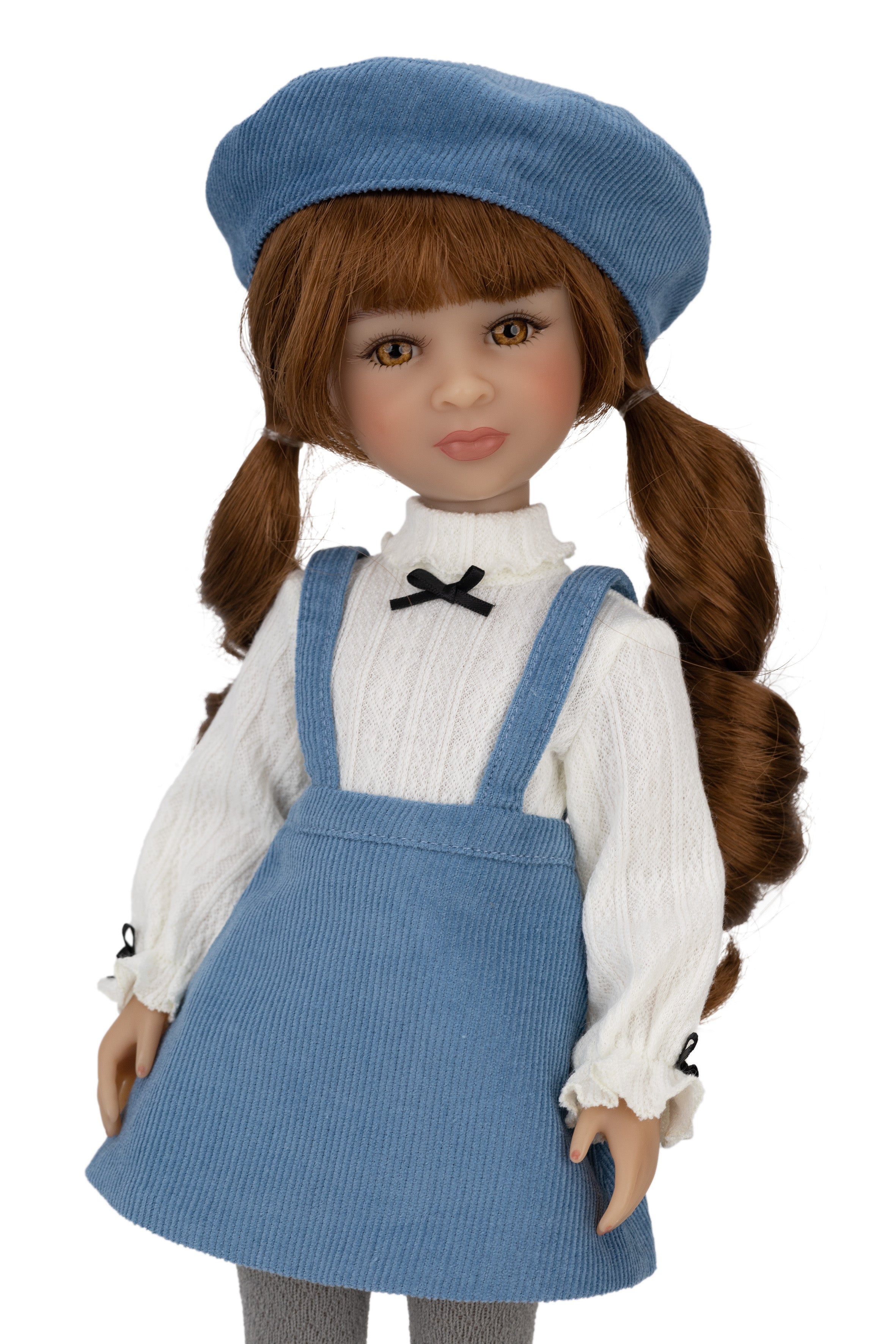 Doll wearing a blue outfit with a white shirt and a blue beret on a white background