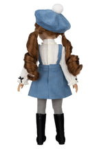 Doll wearing a blue outfit with a white background