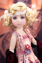 Detailed doll with blonde hair and a decorative outfit against a blurred background
