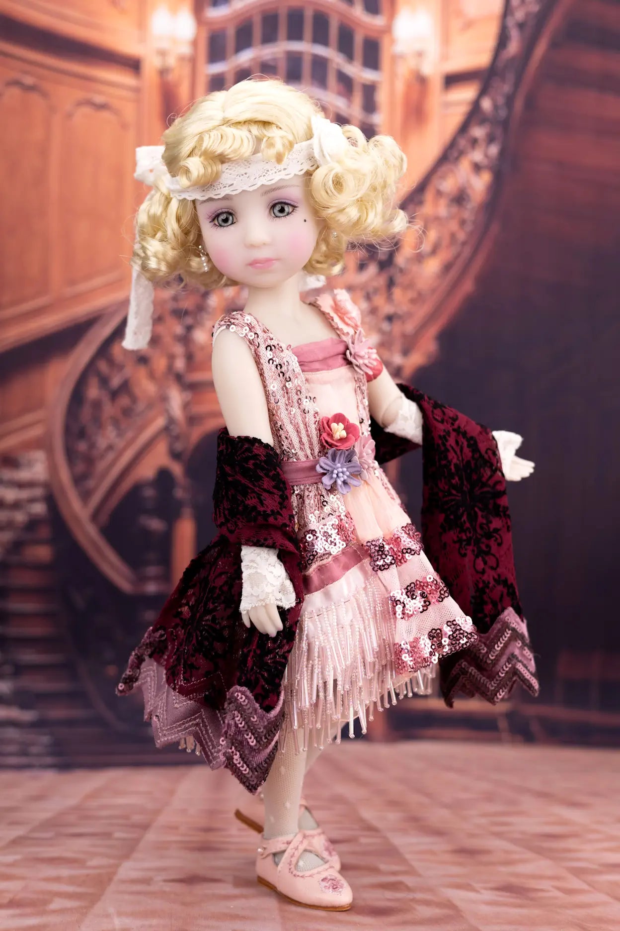 Doll with vintage-style outfit in a decorative setting