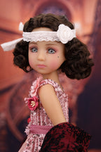 Doll with curly hair and a decorative headband against a blurred background