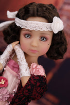 Detailed doll with lace headband and floral accessories against a blurred background