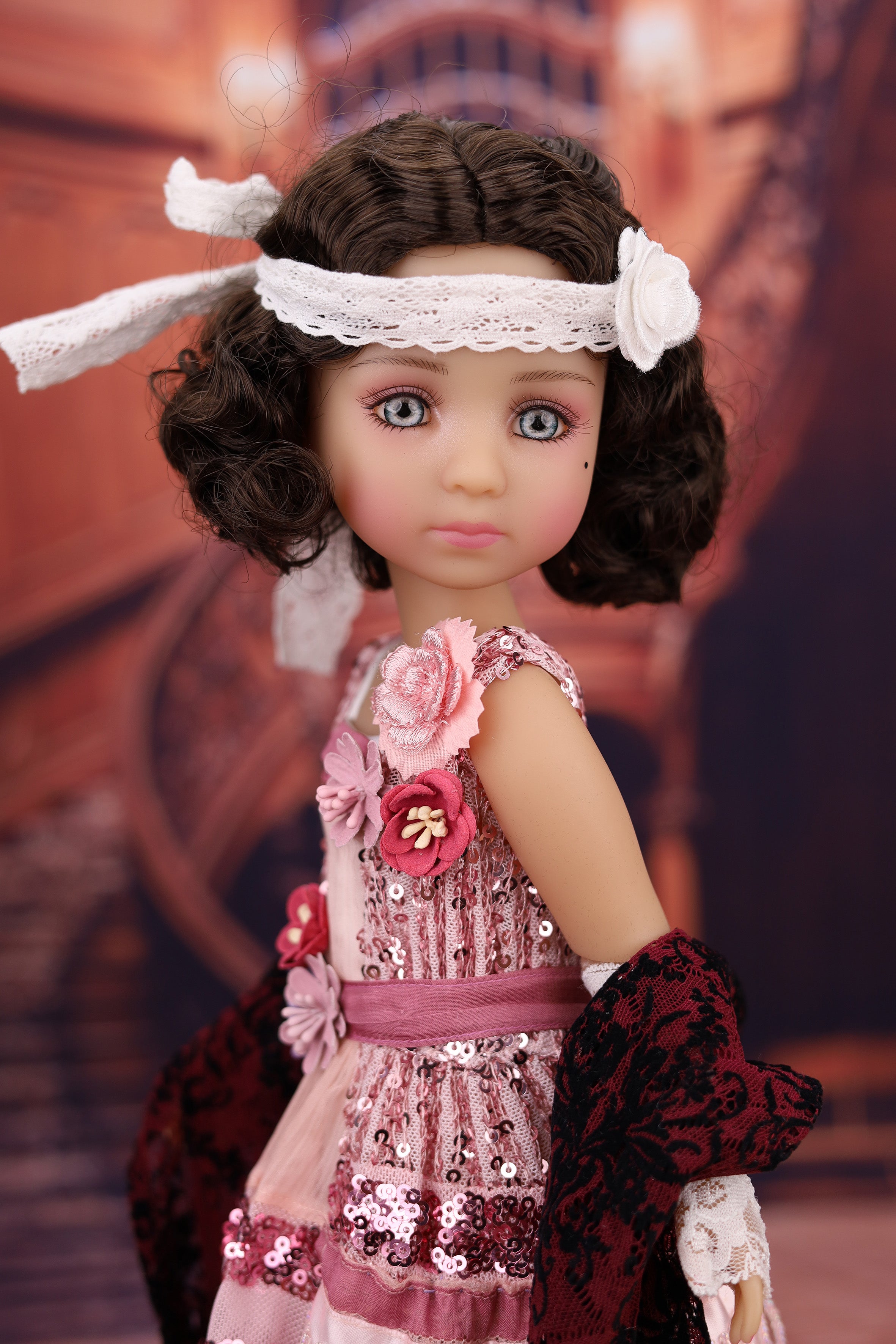 Doll with a detailed outfit and accessories against a blurred background