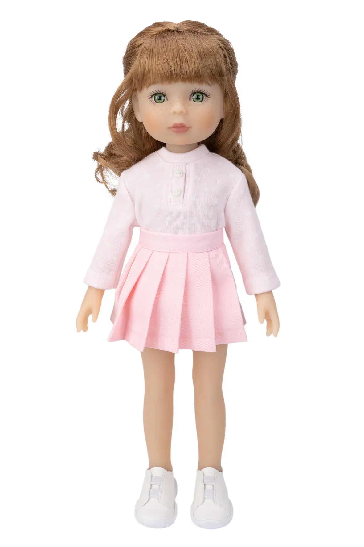 Doll wearing a pink dress with a white shirt on a white background