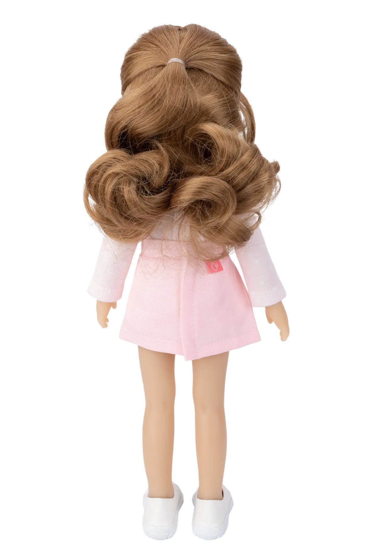 Doll with long brown hair and a pink dress on a white background